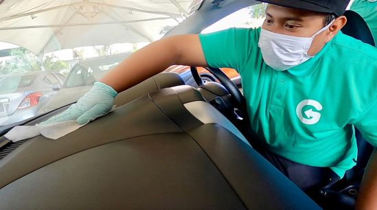 GoCar Fleet Assistant disinfecting the dashboard with antibacterial wipes